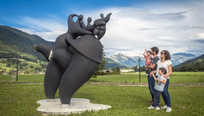 Une famille regarde la sculpture "Promenade sur glace" à la chartreuse de Mélan (Taninges)